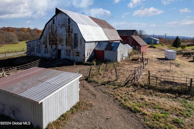 view of barn featuring fence