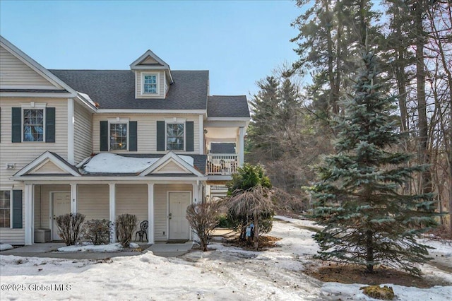 view of front of home featuring a porch and a shingled roof