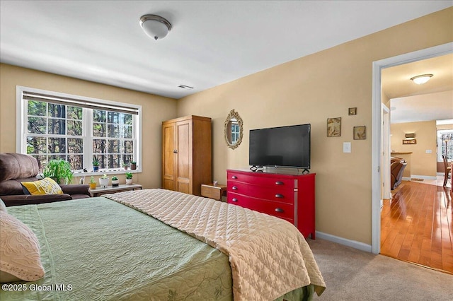 carpeted bedroom featuring baseboards