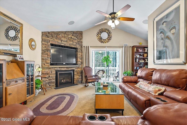 living area with a ceiling fan, vaulted ceiling, carpet flooring, and a fireplace