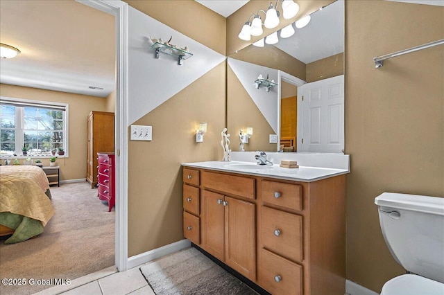 bathroom with baseboards, ensuite bathroom, toilet, and vanity