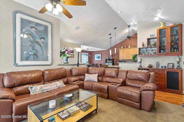 living area with lofted ceiling and a ceiling fan