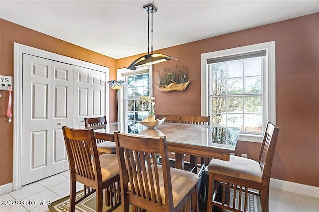 dining room featuring light tile patterned flooring and baseboards