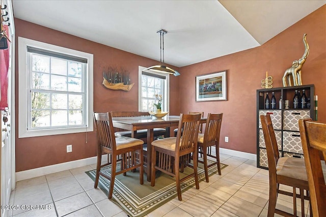 dining area with light tile patterned floors and baseboards