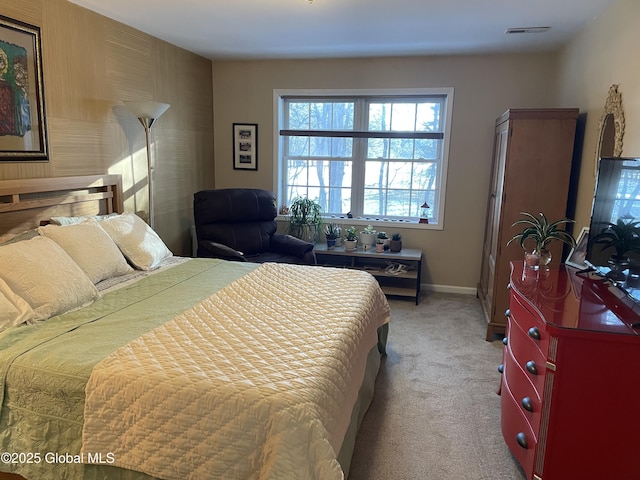 bedroom featuring light carpet, visible vents, and baseboards