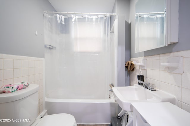 full bathroom with tile walls, toilet, and shower / bath combo with shower curtain