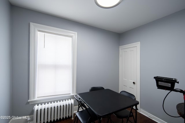 office area featuring radiator heating unit and baseboards