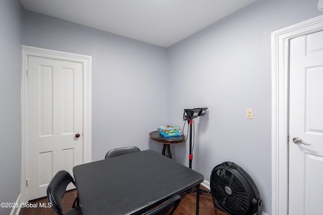 misc room with baseboards and wood finished floors