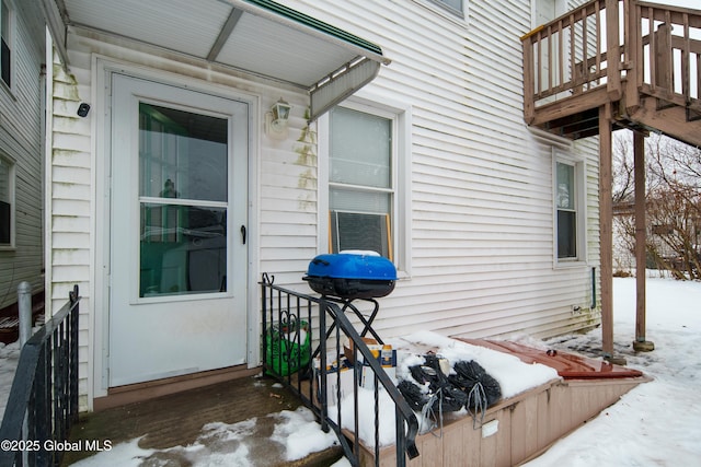 view of snow covered property entrance