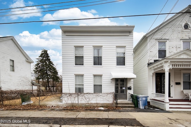 view of front of home with a fenced front yard and a porch