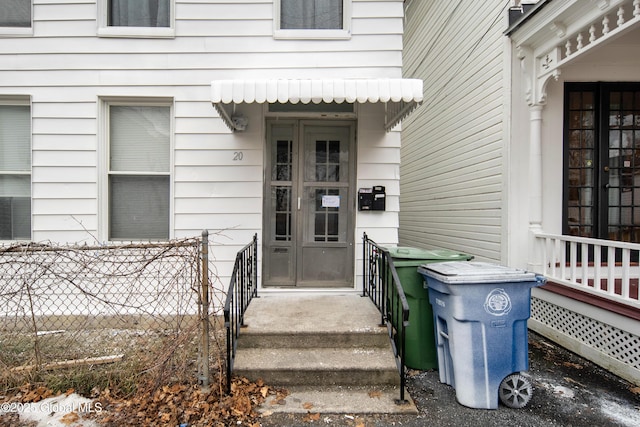 view of exterior entry featuring fence