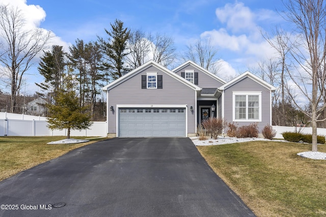 traditional home featuring aphalt driveway, a front lawn, and fence