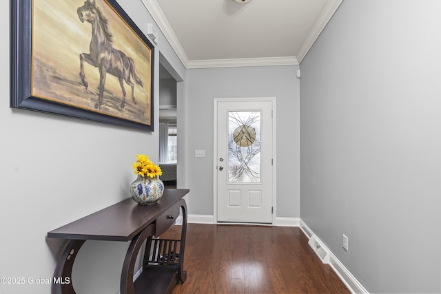 entryway with visible vents, wood finished floors, baseboards, and ornamental molding