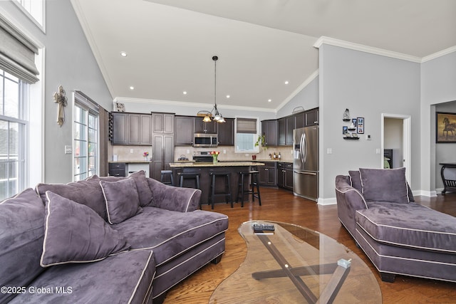 living room with dark wood-style floors, baseboards, and ornamental molding