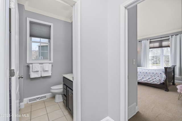 bathroom featuring visible vents, toilet, tile patterned flooring, baseboards, and vanity