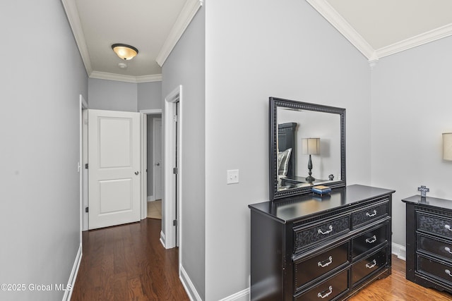 hall featuring wood finished floors, baseboards, and ornamental molding