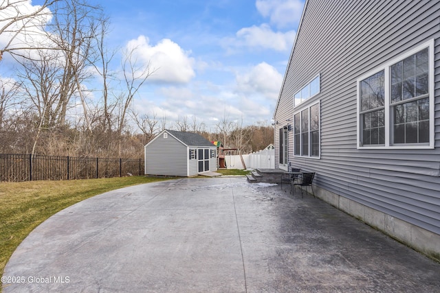 view of patio featuring an outdoor structure and a fenced backyard