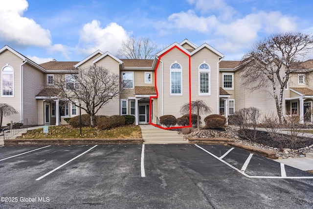 view of property with uncovered parking