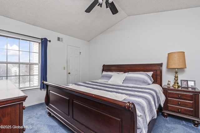 bedroom with dark colored carpet, visible vents, a textured ceiling, and vaulted ceiling