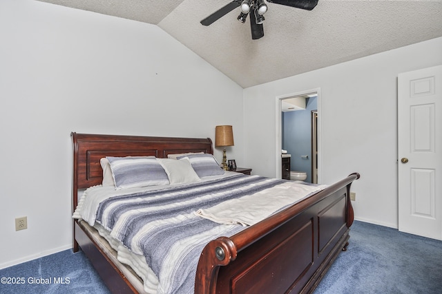 carpeted bedroom with baseboards, vaulted ceiling, a textured ceiling, ensuite bath, and a ceiling fan