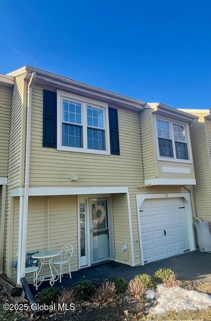 townhome / multi-family property with an attached garage