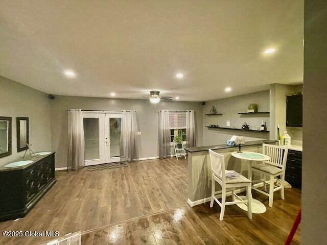 kitchen featuring wood finished floors, baseboards, open shelves, recessed lighting, and french doors