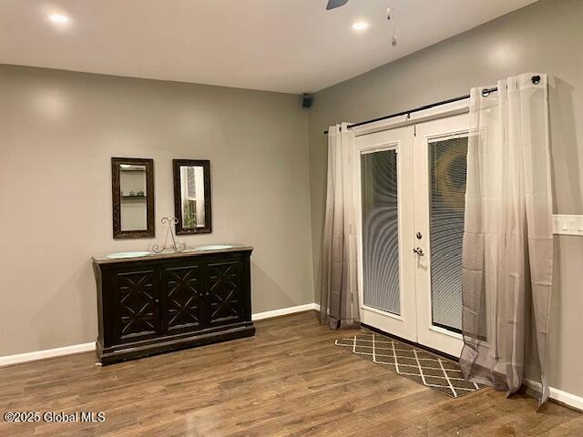 entrance foyer featuring french doors, baseboards, wood finished floors, and a ceiling fan