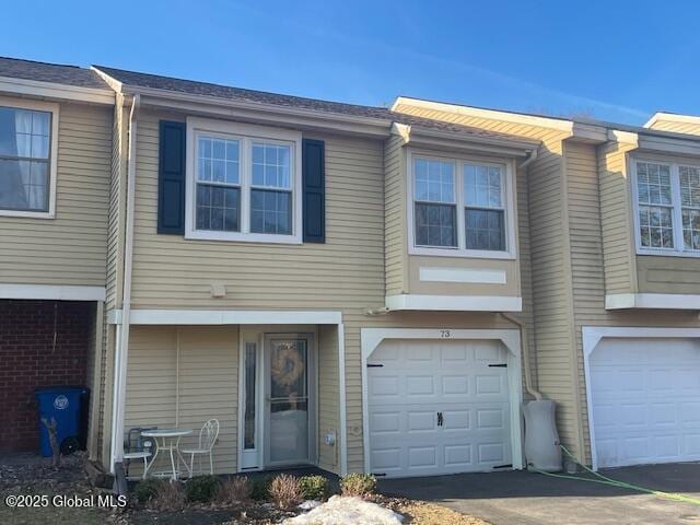 townhome / multi-family property featuring an attached garage and driveway