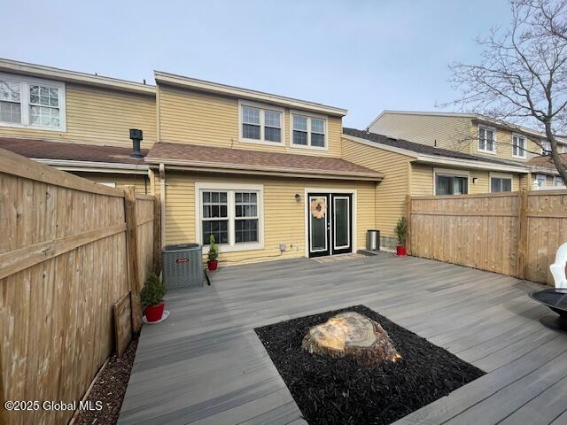 rear view of house with a deck and a fenced backyard