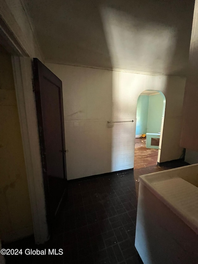 hallway featuring arched walkways