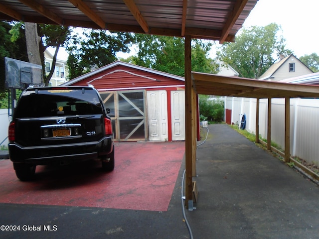 view of vehicle parking featuring fence