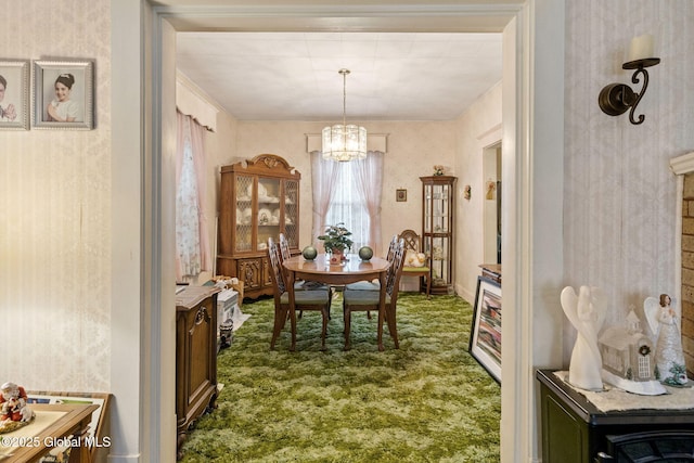 dining area featuring a notable chandelier and dark carpet