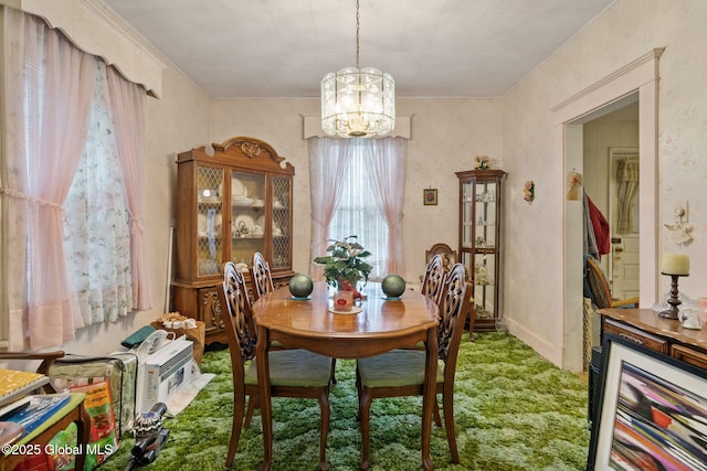 carpeted dining space featuring a chandelier