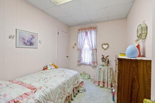 carpeted bedroom with a paneled ceiling