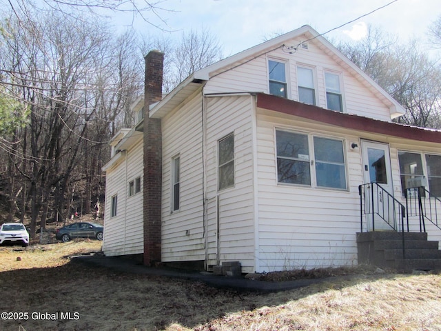 view of front facade featuring a chimney