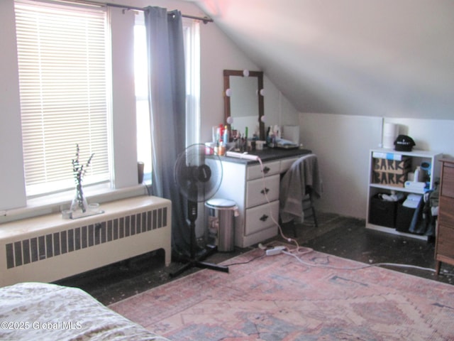 bedroom featuring radiator heating unit and lofted ceiling