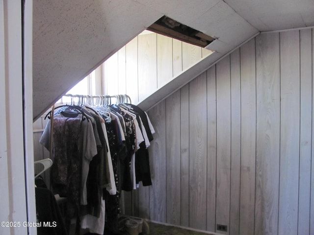 walk in closet featuring vaulted ceiling