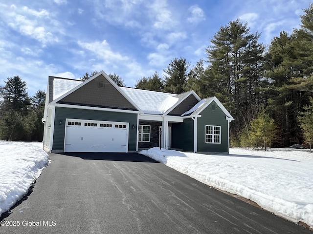 view of front of house with aphalt driveway and an attached garage