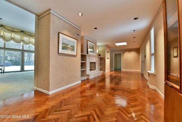 empty room with visible vents, a fireplace, and baseboards