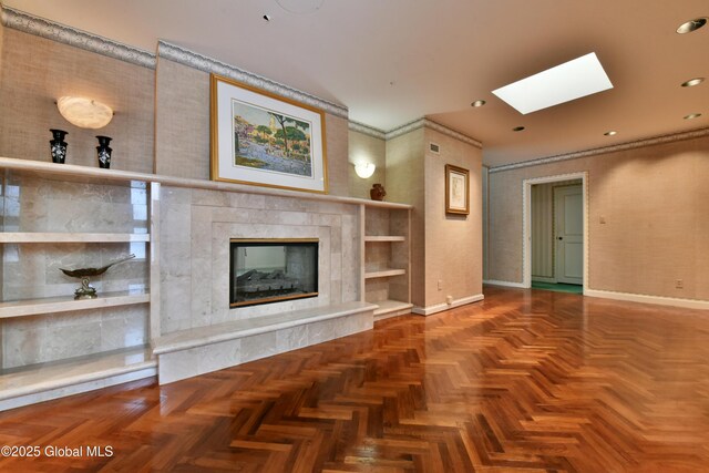 unfurnished living room with a skylight, recessed lighting, a fireplace, and baseboards