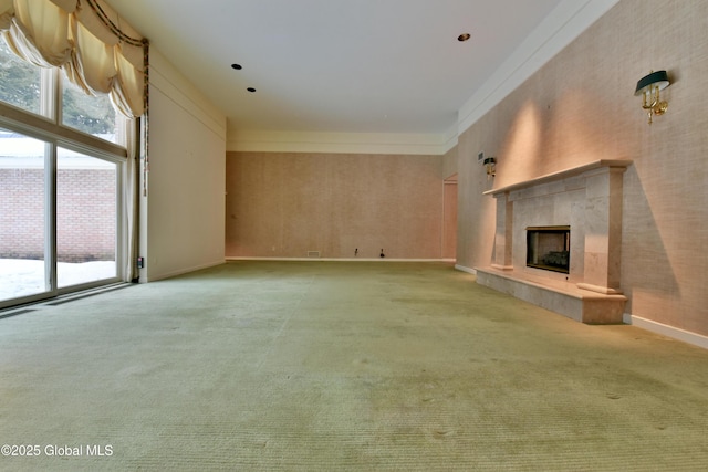 unfurnished living room with light colored carpet, a healthy amount of sunlight, and a fireplace