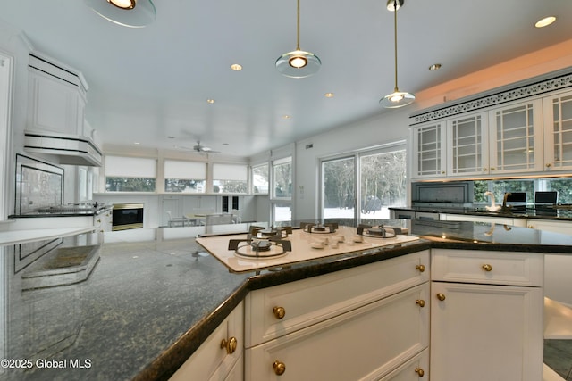 kitchen featuring white gas cooktop, recessed lighting, glass insert cabinets, white cabinetry, and decorative light fixtures