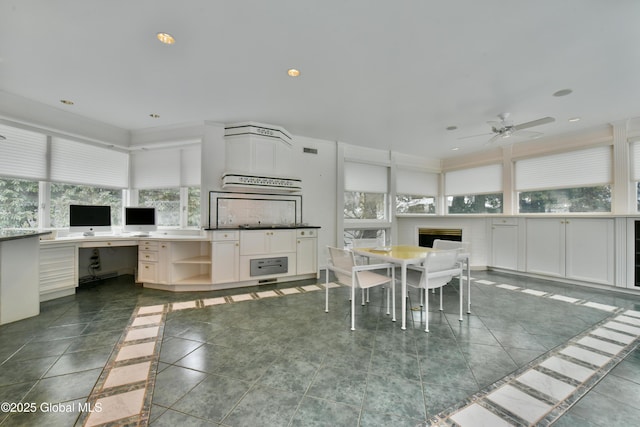 dining area featuring tile patterned floors, built in desk, recessed lighting, and ceiling fan