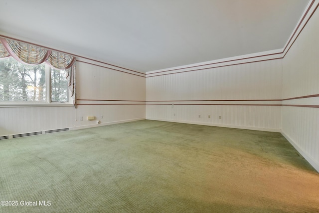 empty room with carpet flooring and a baseboard heating unit