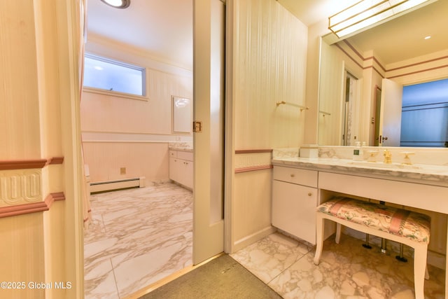 bathroom with baseboard heating, marble finish floor, vanity, and ornamental molding