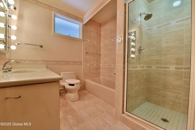 full bath featuring tile patterned flooring, toilet, tiled shower, and vanity