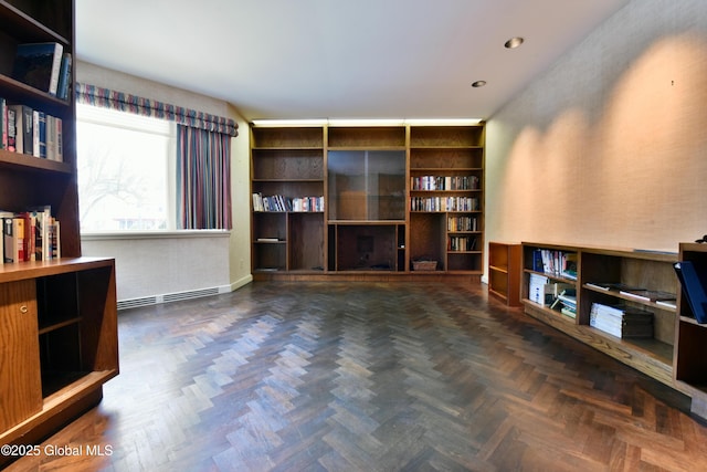 living area with a baseboard heating unit