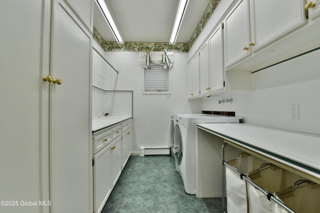 washroom with dark tile patterned floors, baseboard heating, cabinet space, independent washer and dryer, and a sink