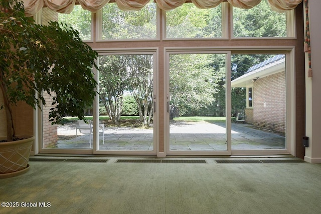 doorway to outside with carpet floors