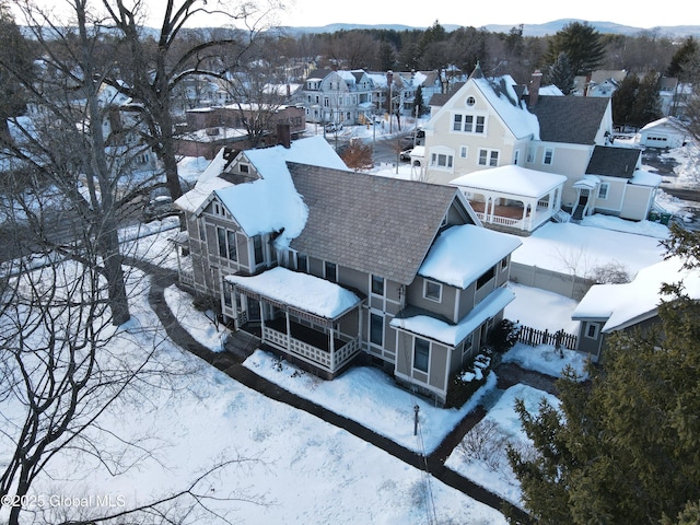 snowy aerial view with a residential view